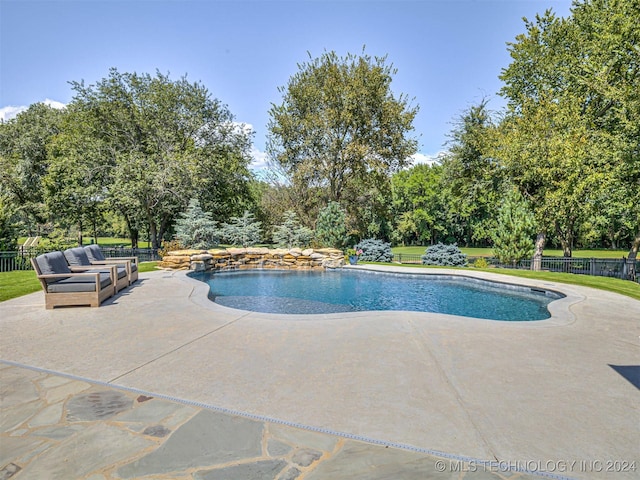 view of swimming pool featuring a patio area