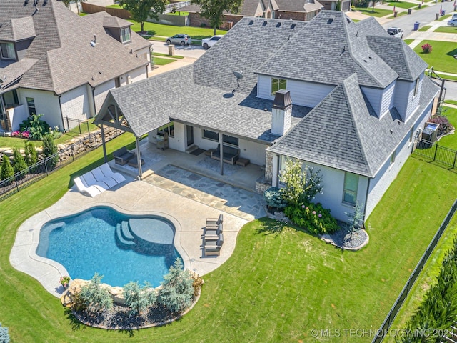 view of pool featuring a yard and a patio