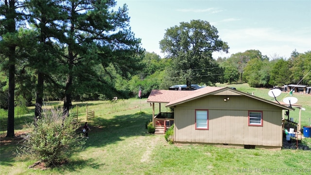 view of side of home with a yard