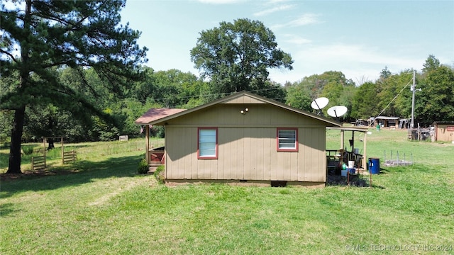 view of side of home with a yard