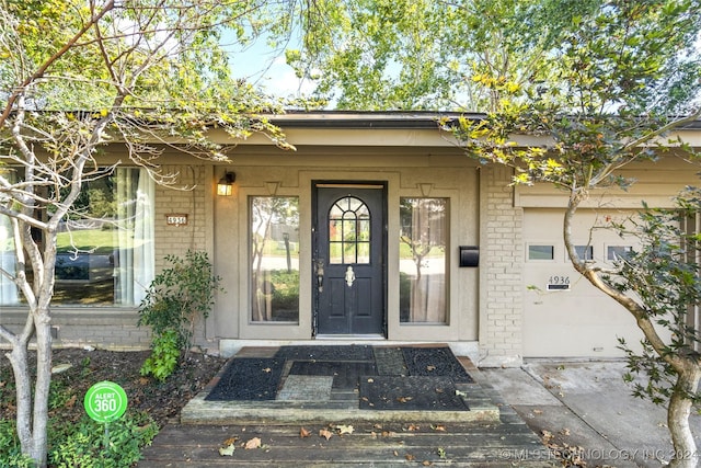 property entrance featuring brick siding