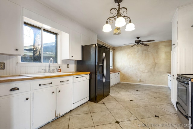 kitchen featuring decorative light fixtures, stainless steel electric stove, white cabinetry, white dishwasher, and a sink