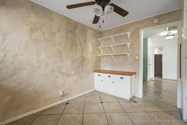 unfurnished room with ornamental molding, light tile patterned flooring, ceiling fan, and visible vents