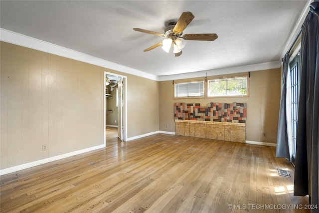 spare room with visible vents, ceiling fan, baseboards, and hardwood / wood-style flooring