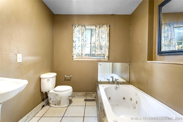 bathroom featuring a whirlpool tub, baseboards, toilet, and tile patterned floors