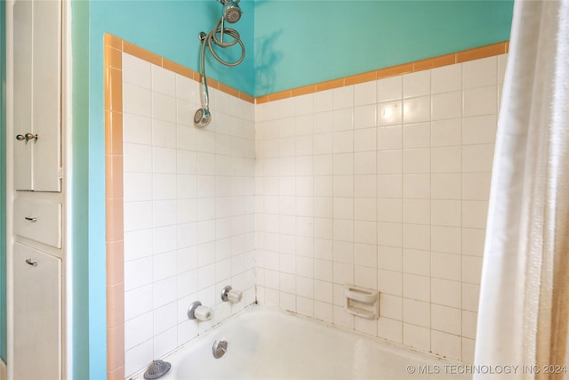 bathroom with shower / bathtub combination with curtain