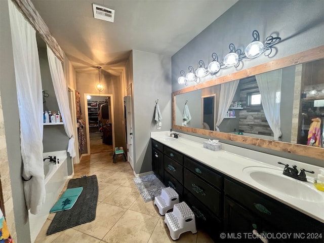 bathroom featuring a bath, tile patterned flooring, and vanity