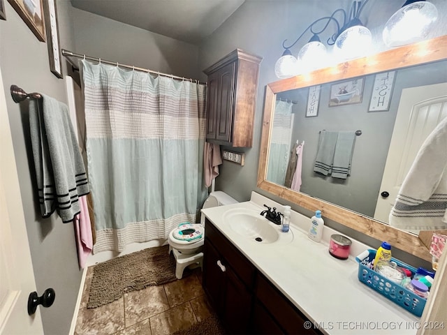 bathroom featuring vanity, toilet, a shower with shower curtain, and tile patterned floors