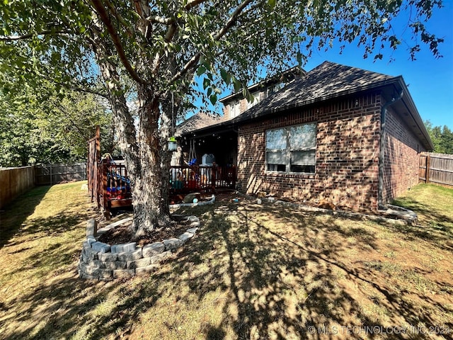 back of house with a lawn