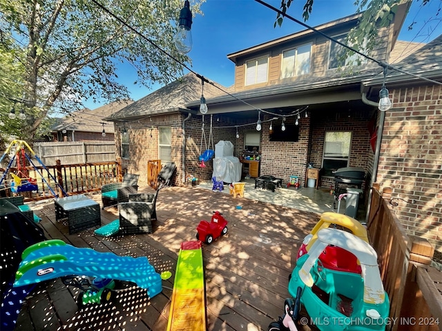 exterior space with an outdoor fire pit and a wooden deck