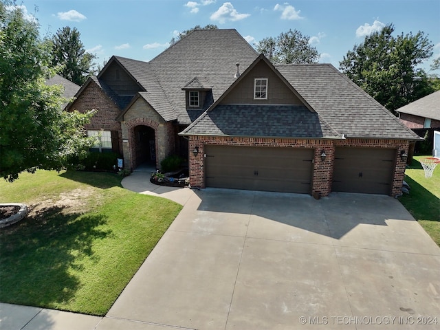 view of front of property featuring a garage and a front lawn