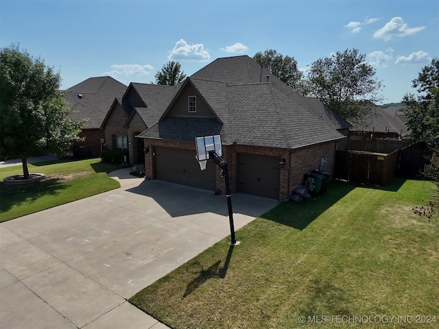 view of front of home with a front lawn and a garage