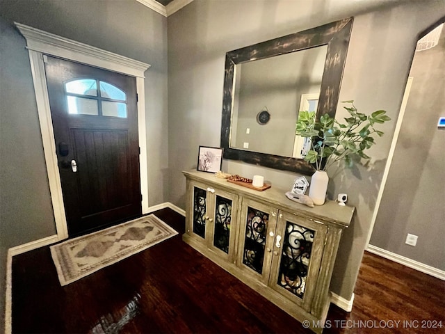 foyer with crown molding and dark wood-type flooring