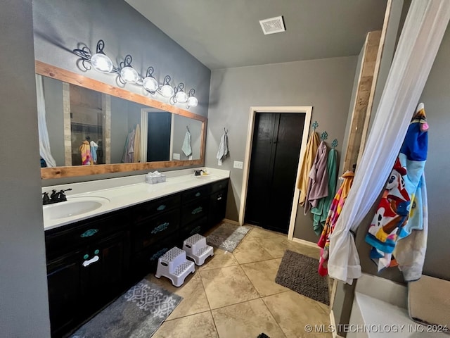 bathroom with vanity and tile patterned flooring