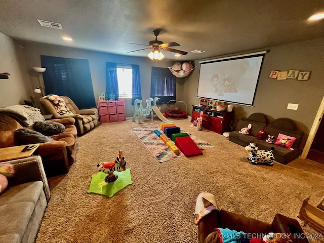 game room featuring a textured ceiling, ceiling fan, and carpet floors