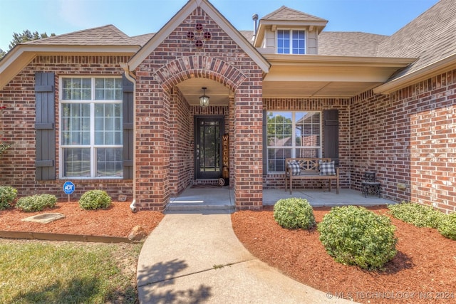 view of exterior entry with a porch