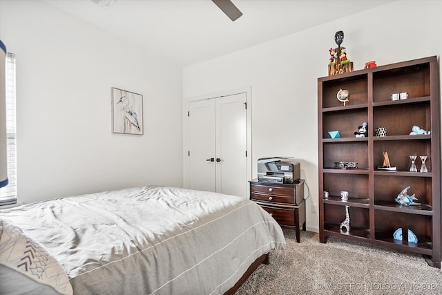 carpeted bedroom featuring ceiling fan and a closet