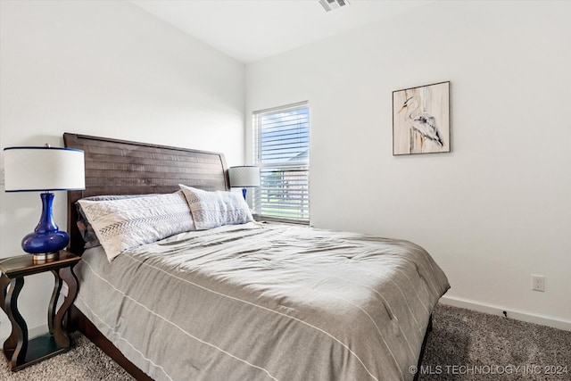 carpeted bedroom with lofted ceiling