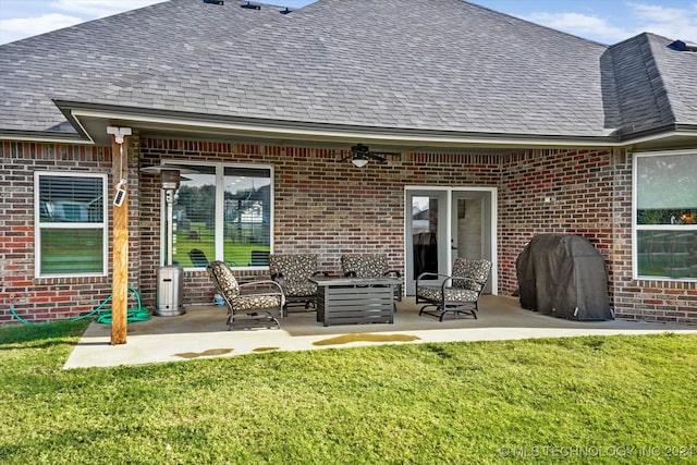 rear view of property with a yard and a patio