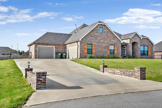 view of front of house featuring a front yard and a garage