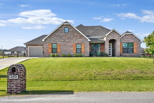 view of front of house with a front lawn and a garage