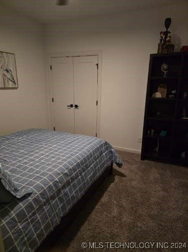 bedroom with carpet and a closet