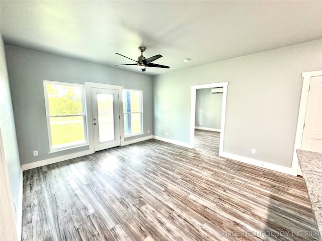 interior space with ceiling fan and wood-type flooring