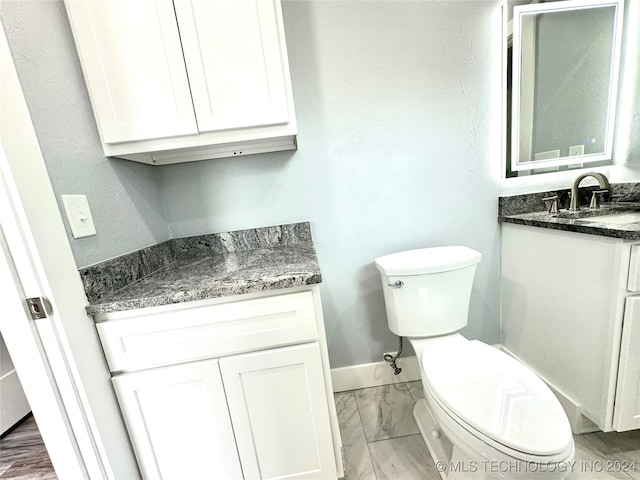 bathroom featuring toilet and vanity