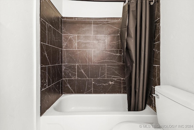 bathroom featuring shower / bath combo and toilet