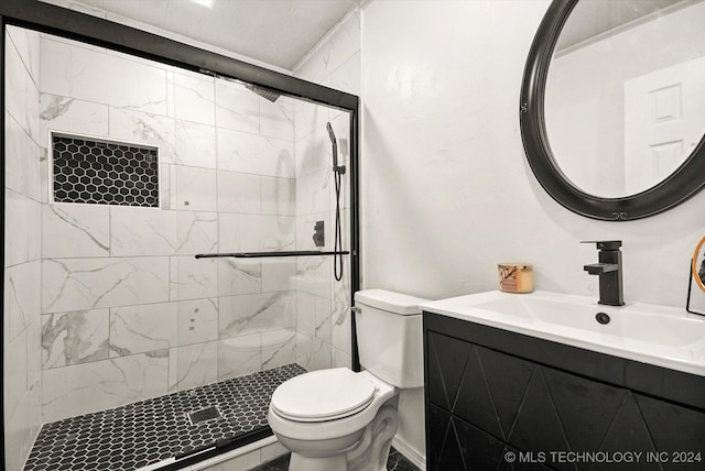 bathroom with vanity, toilet, and a shower with door