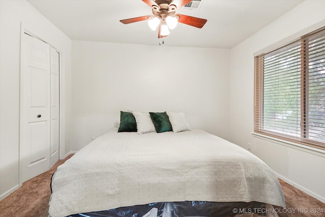 bedroom with carpet floors, ceiling fan, and a closet