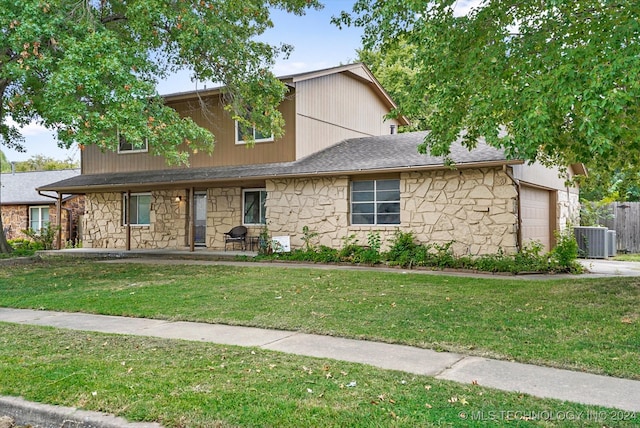 view of front of house featuring central AC unit and a front yard