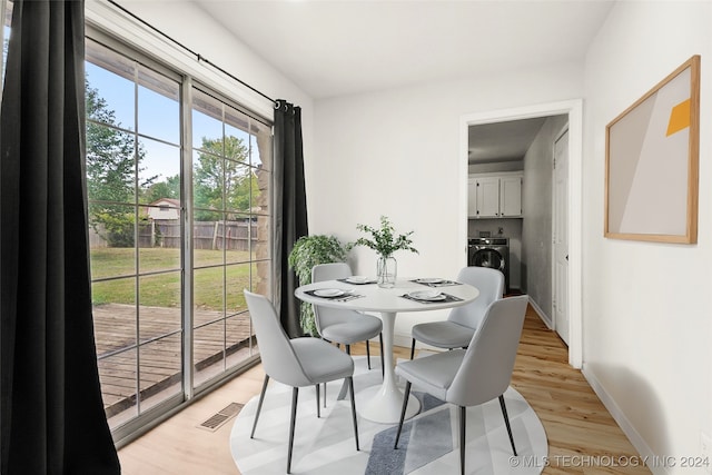 dining space with light wood-type flooring