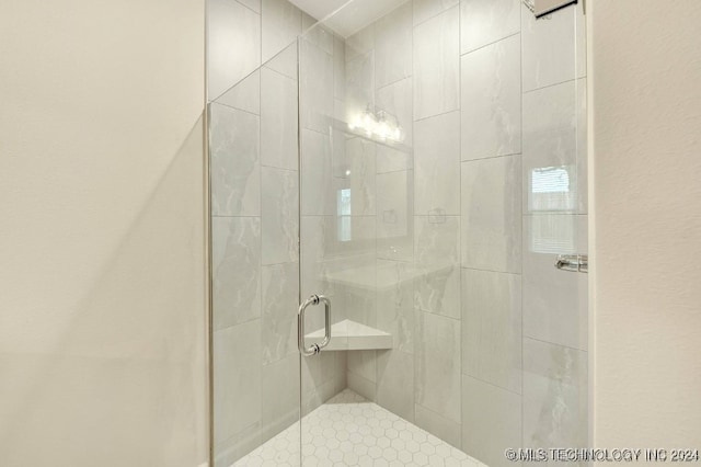 bathroom with a shower with shower door