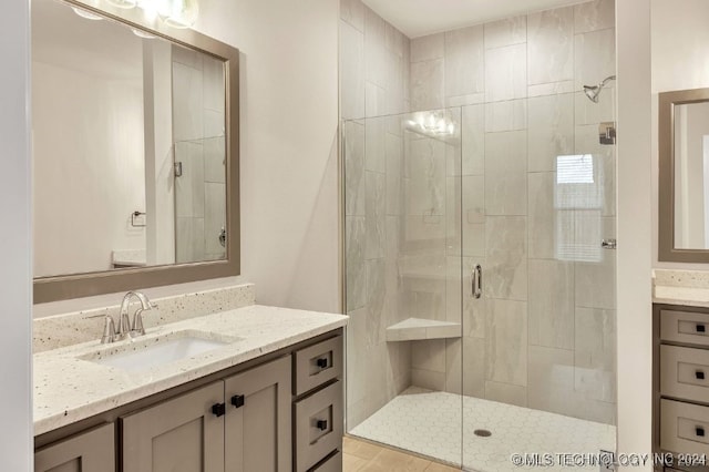 bathroom featuring vanity and a shower with shower door