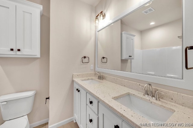 bathroom featuring toilet and vanity