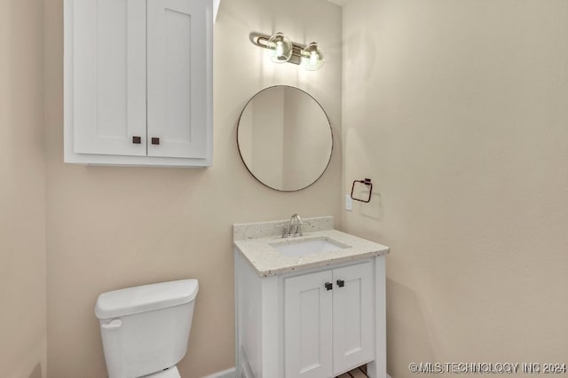 bathroom featuring toilet and vanity