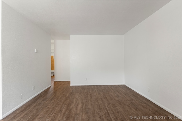 empty room with dark hardwood / wood-style floors