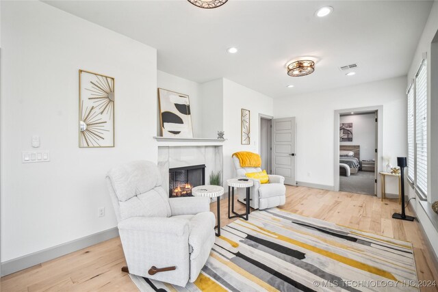 interior space featuring a fireplace and light hardwood / wood-style flooring