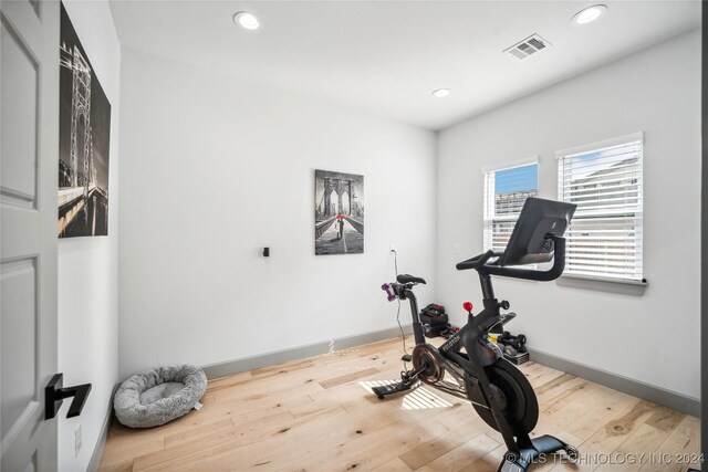 exercise area featuring light hardwood / wood-style floors