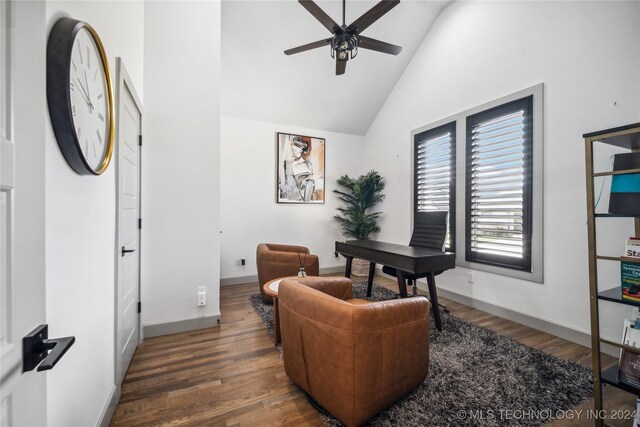 office space with dark wood-type flooring, high vaulted ceiling, and ceiling fan