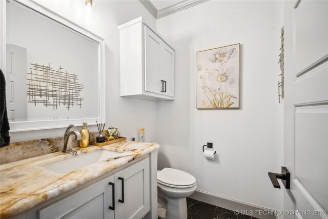 bathroom featuring tile patterned flooring, toilet, ornamental molding, and vanity