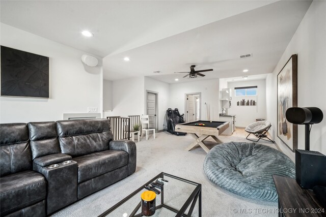 carpeted living room with ceiling fan and pool table