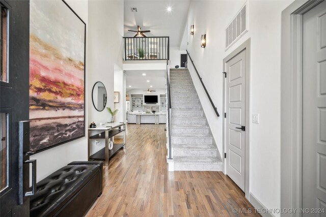 foyer entrance with ceiling fan and hardwood / wood-style flooring