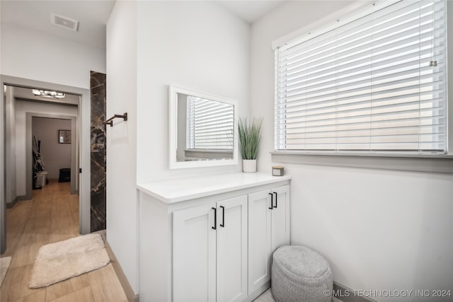 bathroom with vanity and hardwood / wood-style flooring