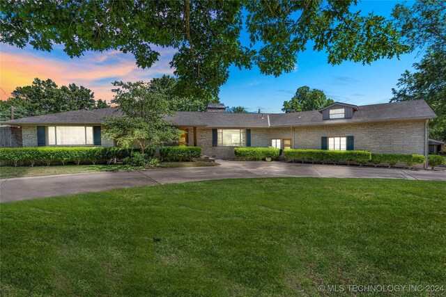 ranch-style house with a lawn