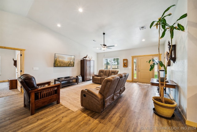 living room featuring wood-type flooring, ceiling fan, and vaulted ceiling