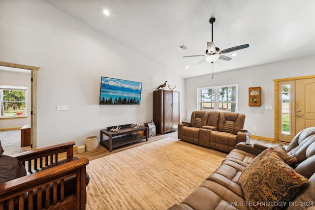 living room with ceiling fan, light wood-type flooring, and vaulted ceiling