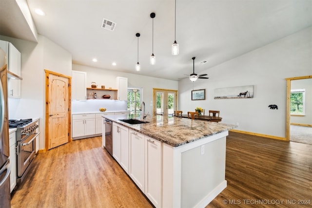 kitchen with a kitchen island with sink, appliances with stainless steel finishes, plenty of natural light, and sink