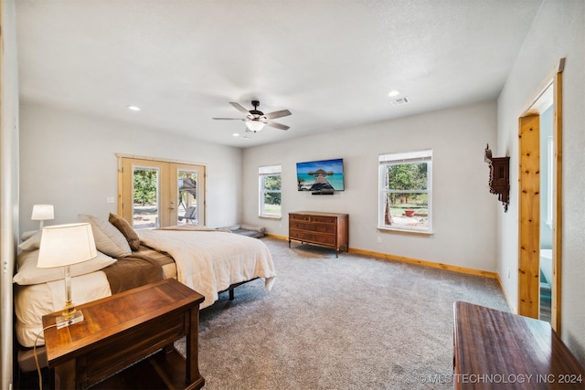 carpeted bedroom with multiple windows, access to outside, and ceiling fan